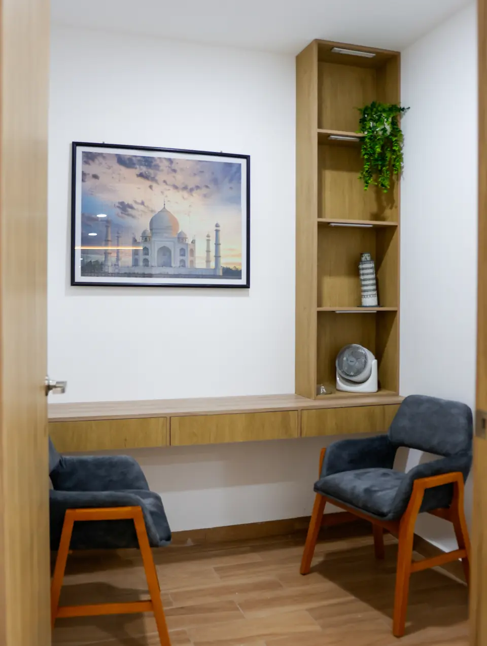 Consultorio privado con dos sillas y librero de madera